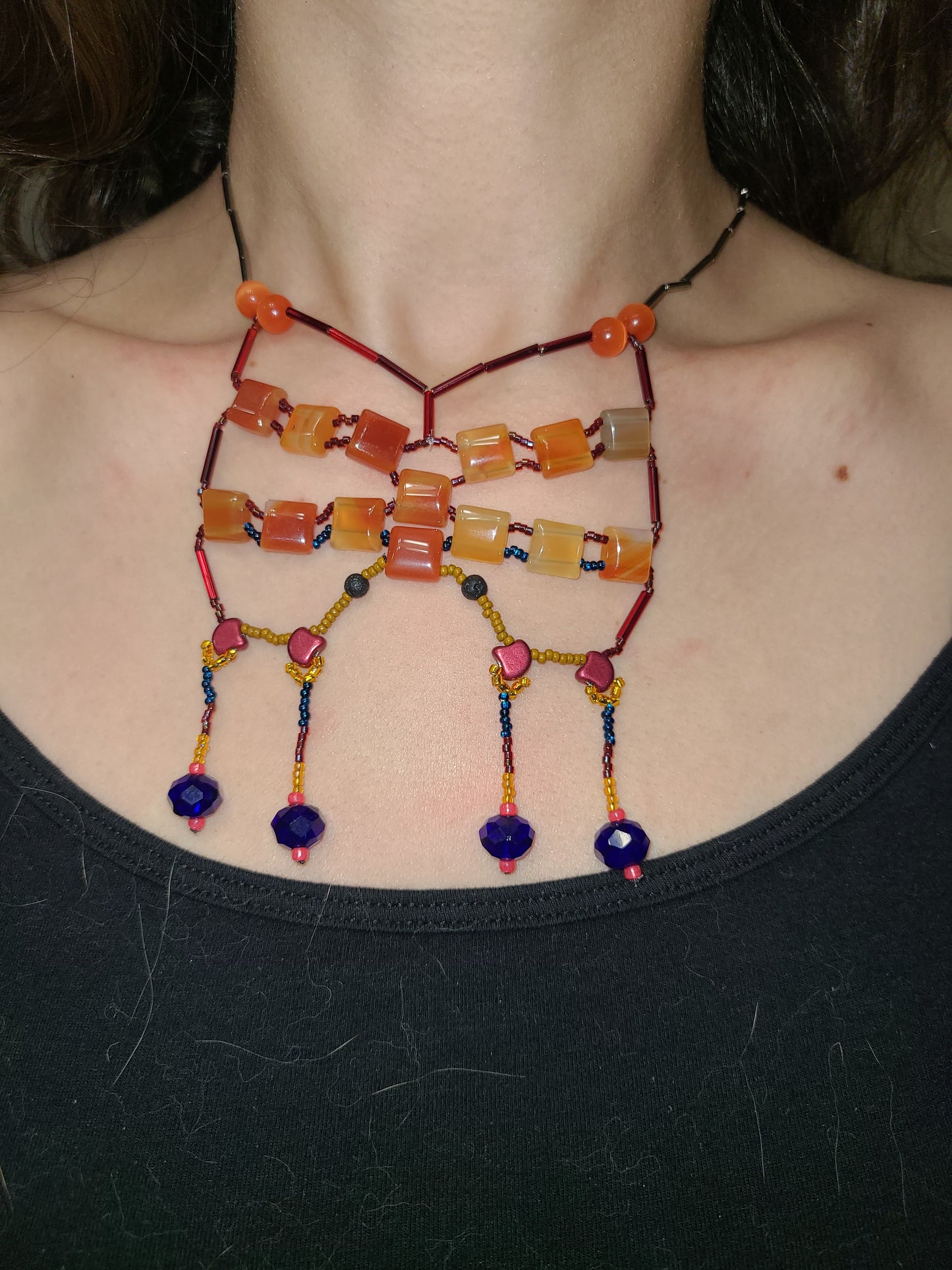 Woman wearing carnelian starlit sands statement necklace.