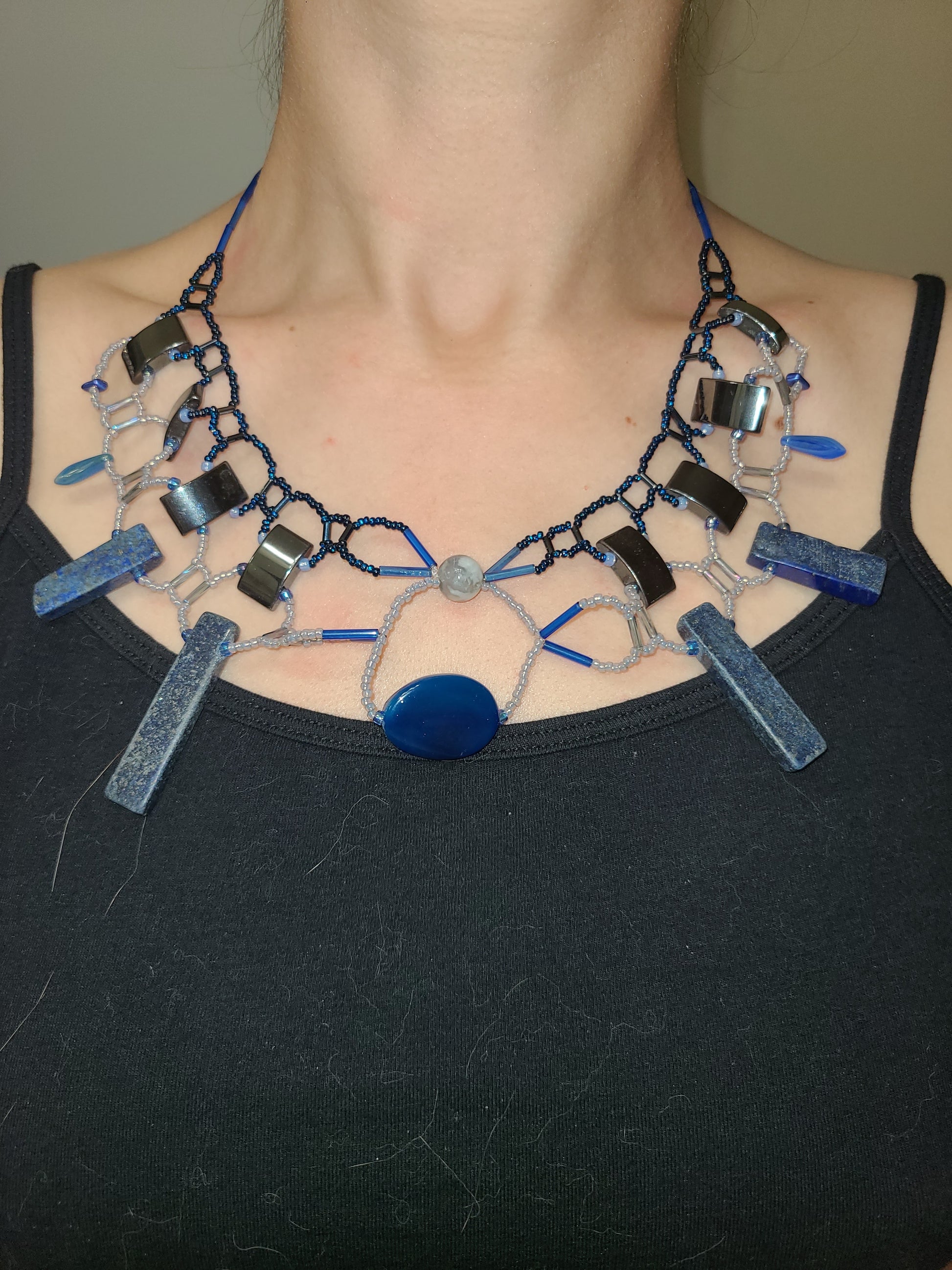 Woman wearing lapis and agate statement necklace