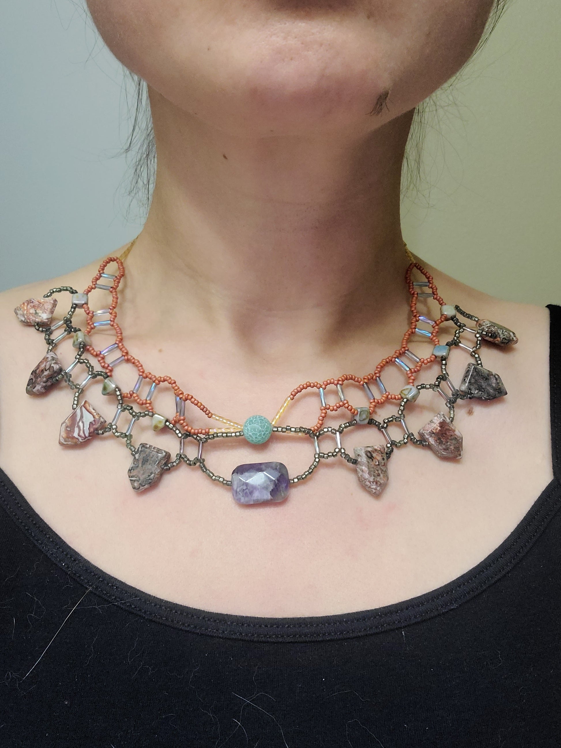 Woman wearing picture jasper and amethyst collar necklace