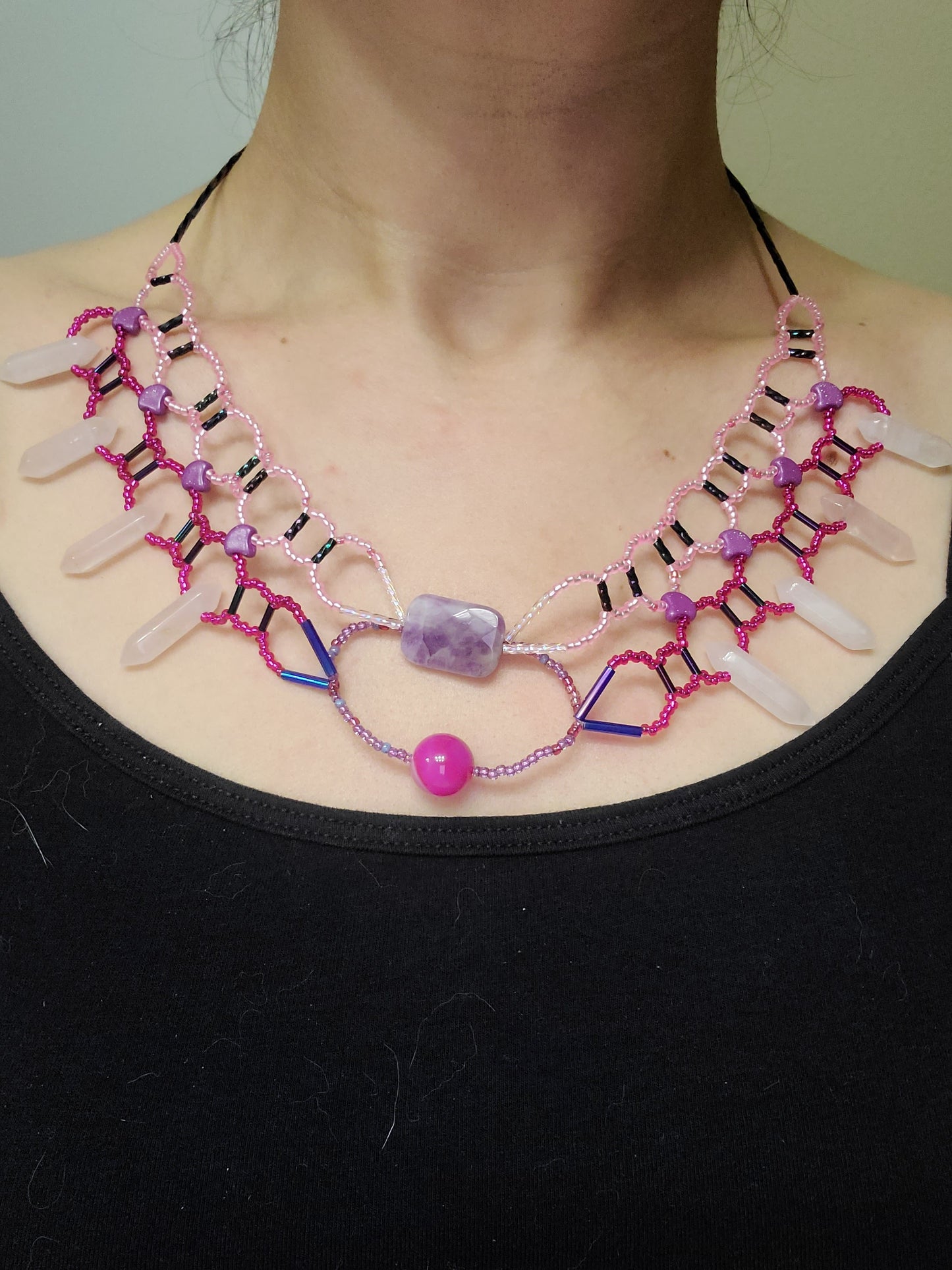 Woman wearing pink-toned collar necklace with rose quartz agate and amethyst