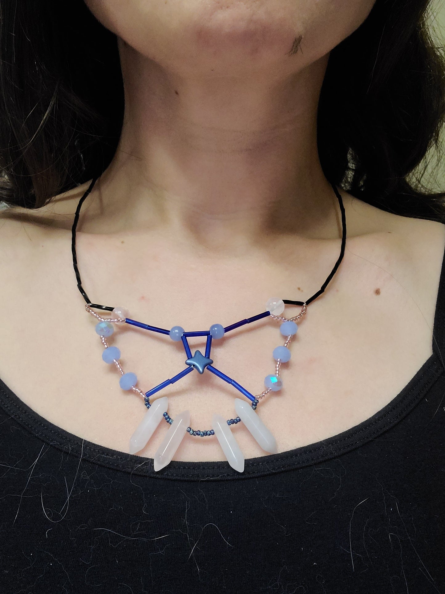 Woman waring fairy butterfly rose quartz statement necklace