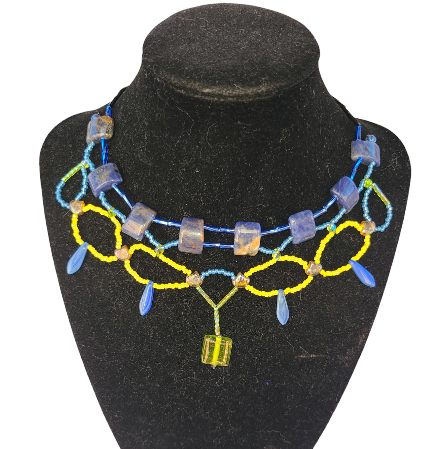 Blue and yellow sodalite necklace with bottle green statement bead.