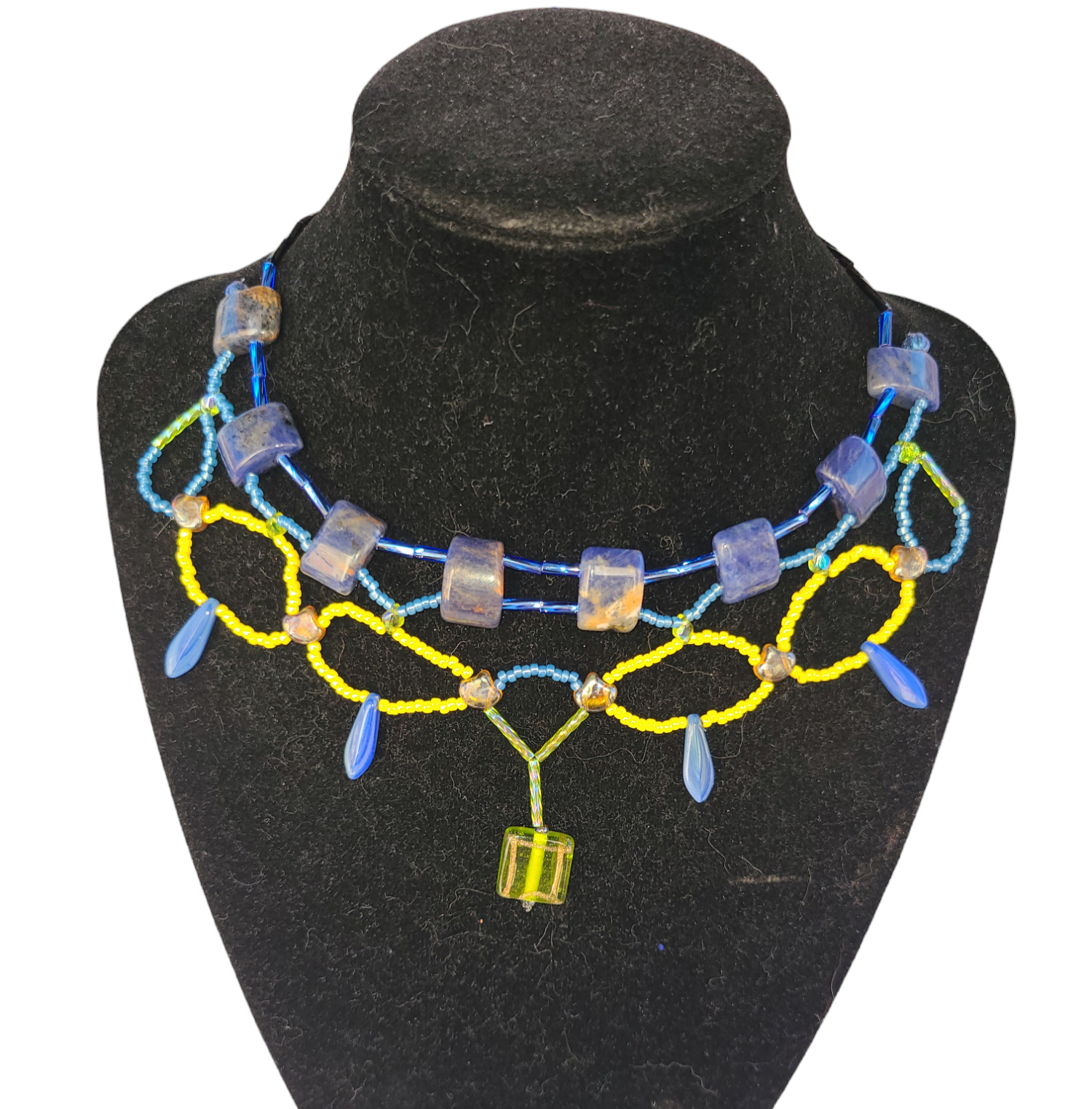 Blue and yellow sodalite necklace with bottle green statement bead.