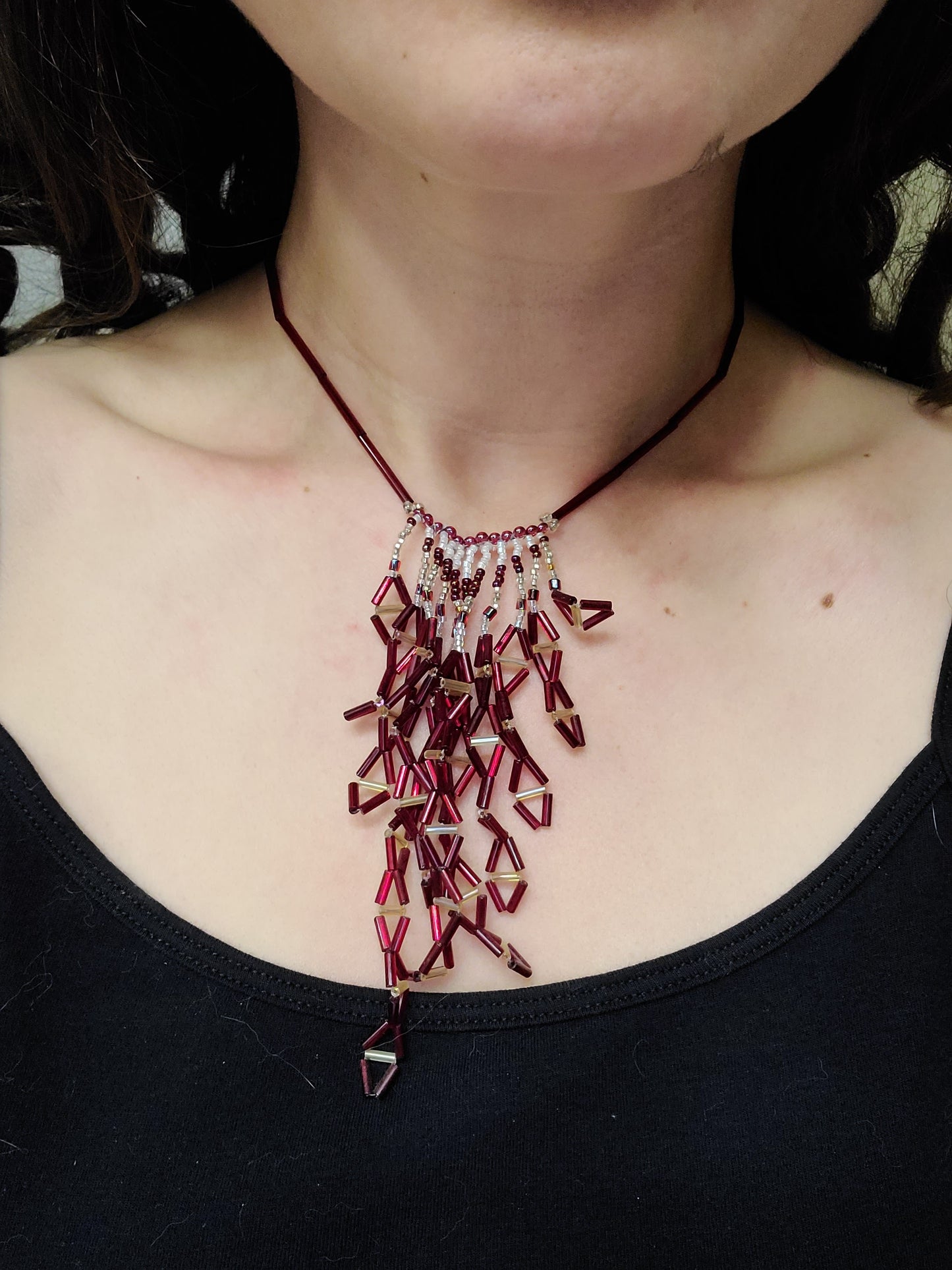Model wearing deep red diamond fringe necklace.