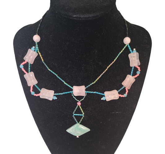 Dramatic teal and pink Y-shaped necklace featuring rose quartz beads and an amazonite bead at the center. 