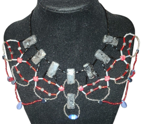 Black labradorite geometric beaded statement necklace with red glass and powder blue drop fringe, front view