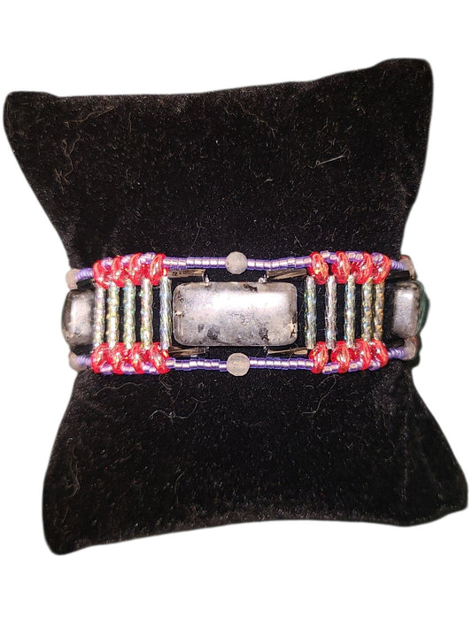 Wide black labradorite beaded cuff with segmented Roman road construction, gray columns, blue-violet border, red glass junctions