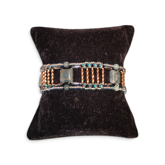 Wide moss agate beaded cuff with segmented Roman road construction, gunmetal columns, bronze rails, teal silver-lined border