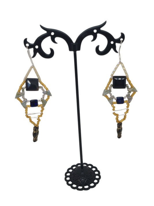 Black onyx beaded girandole earrings in gold and black diamond spindle form with glass owl drop, front view