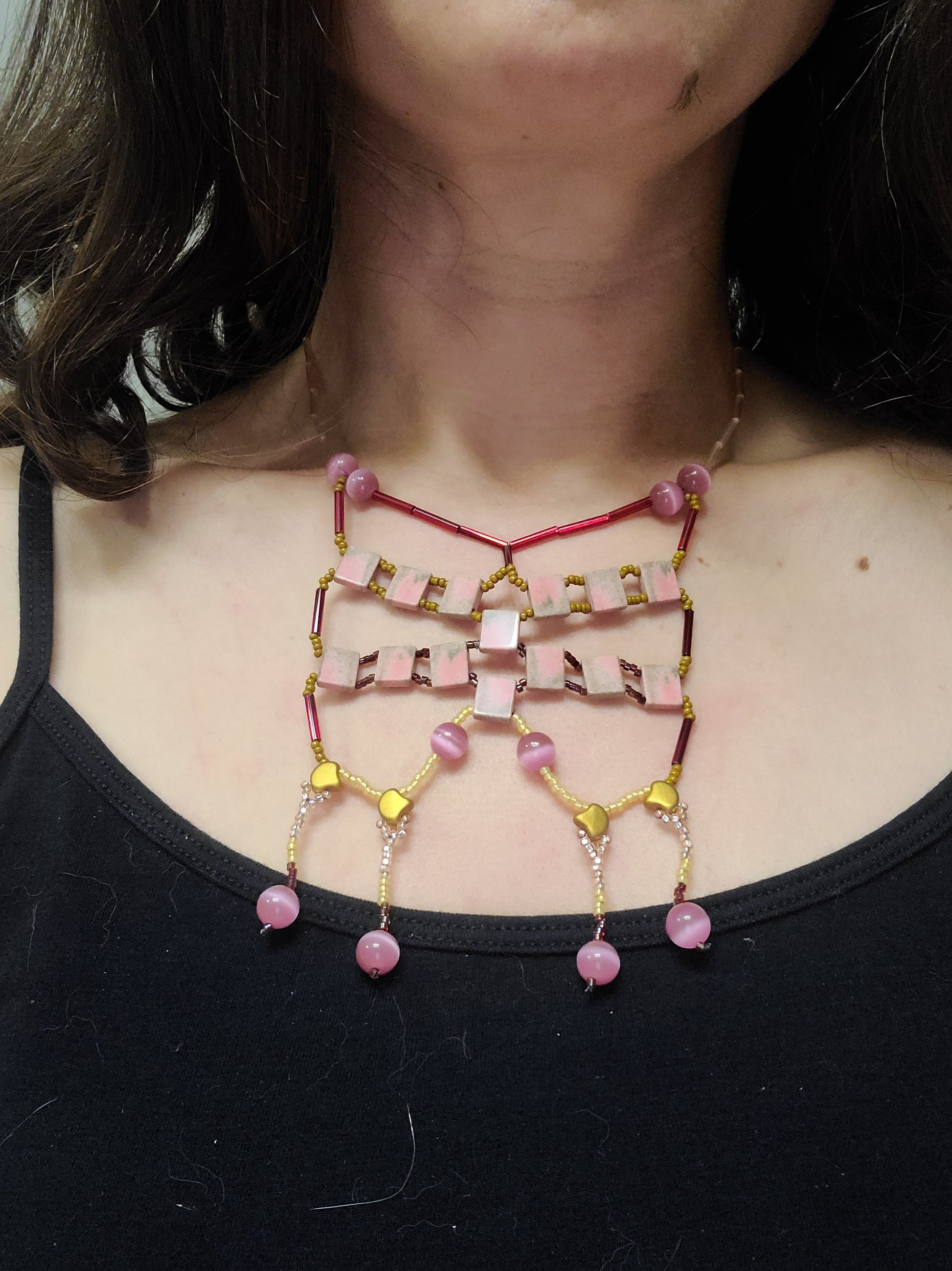 Dark-haired woman wearing bright colored agate statement necklace